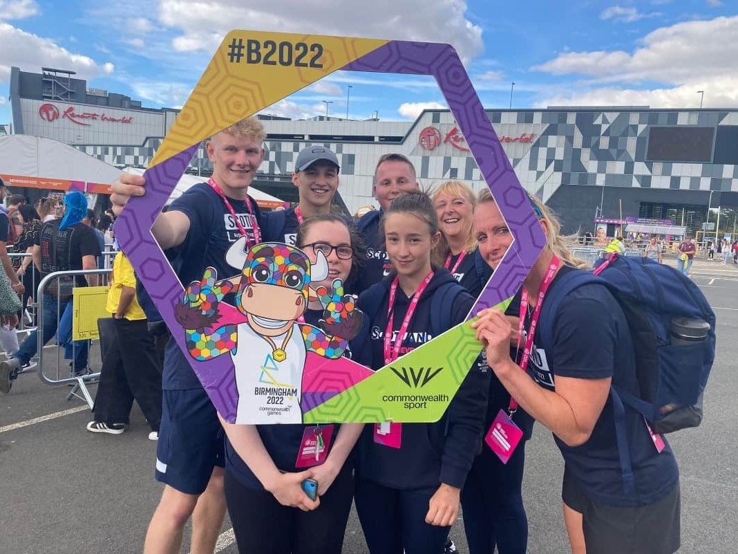 Achieve Programme Participants stand in a Birmingham 2022 Commonwealth Games Frame