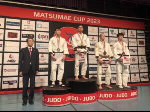 James gray on the Podium at the Matsumae Cup. photo credit Destination Judo.
