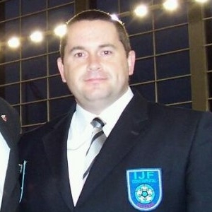 David McSkimming looks directly at the camera, dressed in his IJF referee uniform.