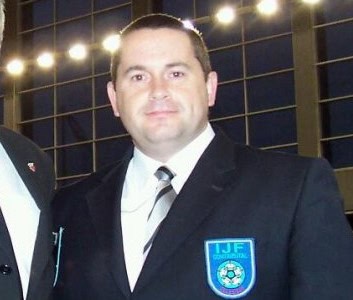 David McSkimming looks directly at the camera, dressed in his IJF referee uniform.