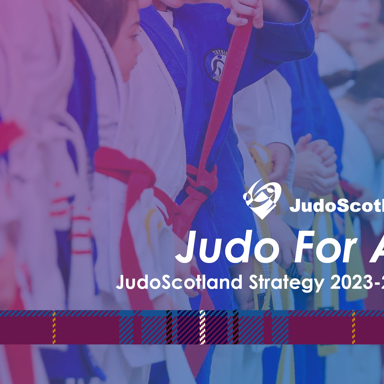 Judo For All: Young Judoka line up ready to take part in a judo session, a mix of belts ages and abilities.
